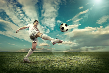 Fototapeta na wymiar Soccer player with ball in action outdoors.