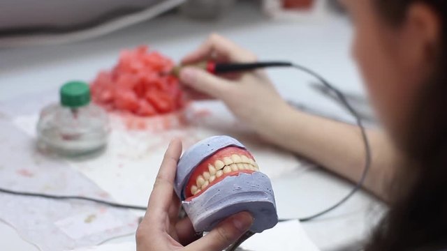 Dentistry. Prosthetist produces the prosthesis model