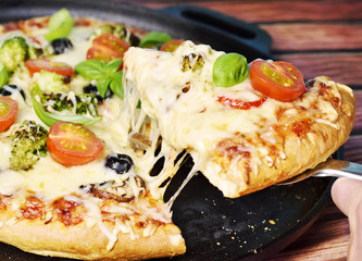 Fresh cheesy pizza, pizza slice with tomatoes, Basil and vegetarian ingredients. Veggy Pizza.