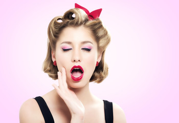 Beautiful young woman with pin-up make-up and hairstyle