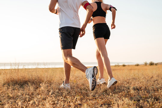 Young fitness man and woman doing jogging sport outdoors