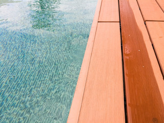 Obraz premium swimming pool with wooden path