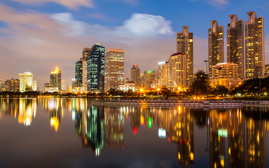 Fototapeta na wymiar Bangkok at twilight with light and reflection, view from Benjakitti park, Bangkok Thailand