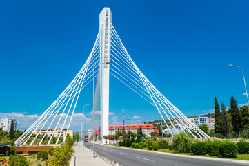 Fototapeta na wymiar Wonderful white Millennium bridge structure over clear blue sky in Podgorica, Montenegro