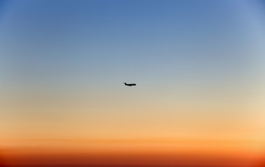 Fototapeta na wymiar Plane in the sky at sunset/ fly/ high/ sun/