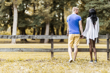 Happy couple in love holding hands in a park