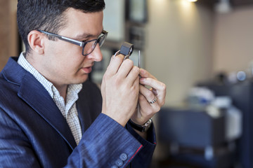 Jeweler examining diamond through loupe