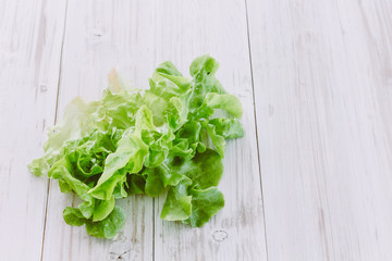 Green vegetables on wooden background - healthy eating concept