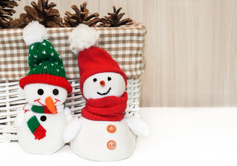 Christmas decoration with smiling snowman toy.