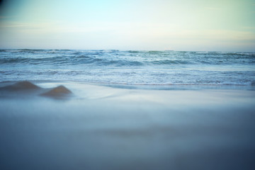 Peaceful scene of a calm sea beach, pastel colors.