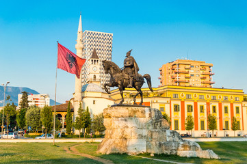 Skanderbeg square with flag, Skanderbeg monument and The Et'hem Bey Mosque in the center of Tirana city, Albania.