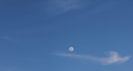 blue sky background with clouds and the moon