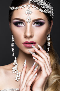 Beautiful girl in the image of the Arab bride with expensive jewelry, oriental make-up and bridal manicure. The beauty of the face. Photos shot in the studio.