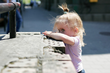 Cute girl standing near the wall