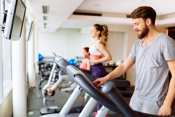 Fototapeta premium People running on treadmill in gym