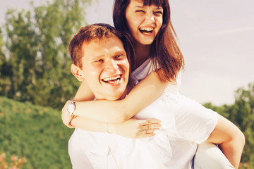 Loving young beautiful couple on a date in park. summer warm weather