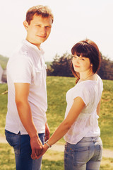 Obraz premium Loving young beautiful couple on a date in park. summer warm weather
