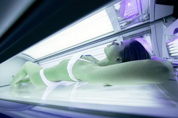 Beautiful woman lying in solarium