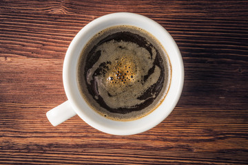 Flat lay of coffee cup over old wooden background