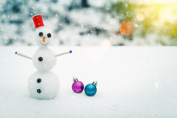 Smiling snowman and Christmas decorations. Picturesque winter landscape. Holiday mood. Beautiful New Year composition.