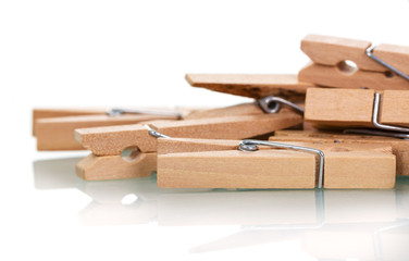 Wooden clothespins close-up isolated on white.