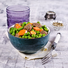 Meat stew with peas and carrots