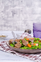 Meat stew with peas and carrots