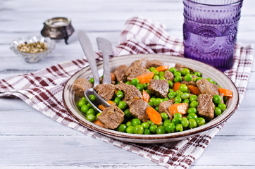 Meat stew with peas and carrots