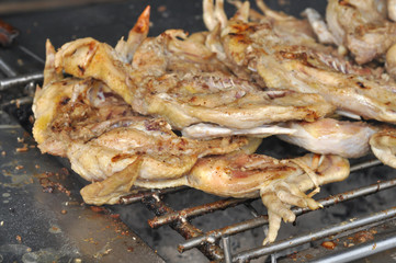 Chicken grilled over a charcoal fire