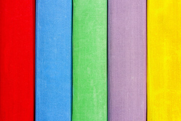 Fototapeta premium Books on the shelf closeup. The texture of multi-colors textbooks.