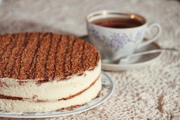 delicious cake on a plate and tea