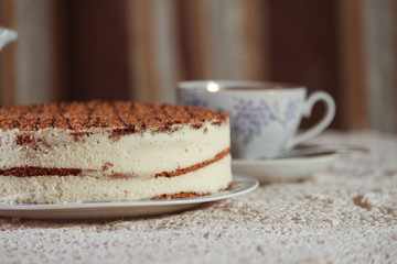 delicious cake on a plate and tea