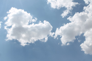 white storm clouds against a blue sky