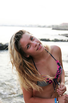 Woman standing on the beach and posing