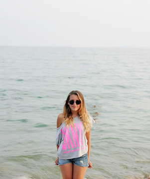 Nice girl standing by the sea