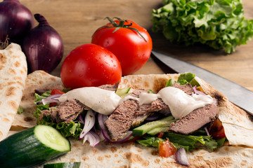 Doner kebab - fried beef meat with vegetables