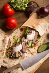 Doner kebab - fried beef meat with vegetables