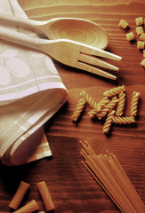 Fototapeta na wymiar various types of pasta on a wooden table 