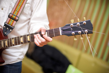 male musician playing acoustic guitar