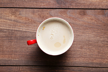 Cup of coffee on a brown wooden table
