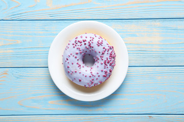 Sweet donuts on blue wooden table