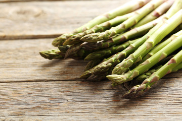 Fresh green asparagus on a grey wooden table