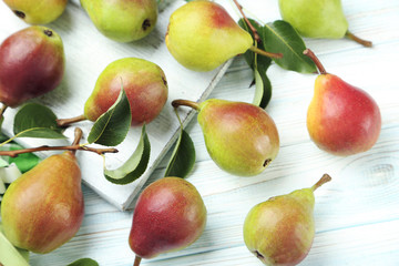 Ripe pears on white wooden table