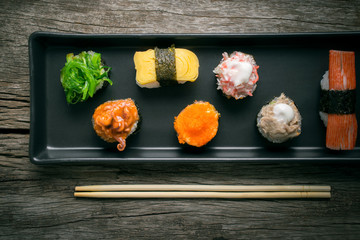 Sushi Set and sushi rolls served on wood table.