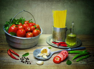 Still life food with fresh organic ingredients for cooking Italian pasta placed on rustic wooden table.