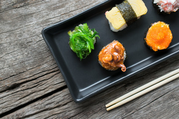 Sushi Set and sushi rolls served on wood table.