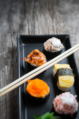 Sushi Set and sushi rolls served on wood table.