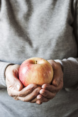 Hands holding a beautiful apple