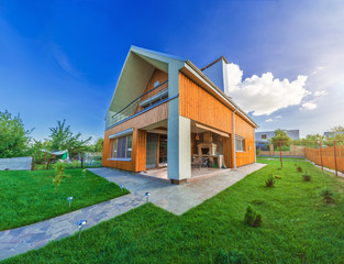 Fototapeta premium Beautiful wooden house with a lawn.