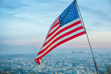 American flag on Hollywood Hills blowing in the wind against a b